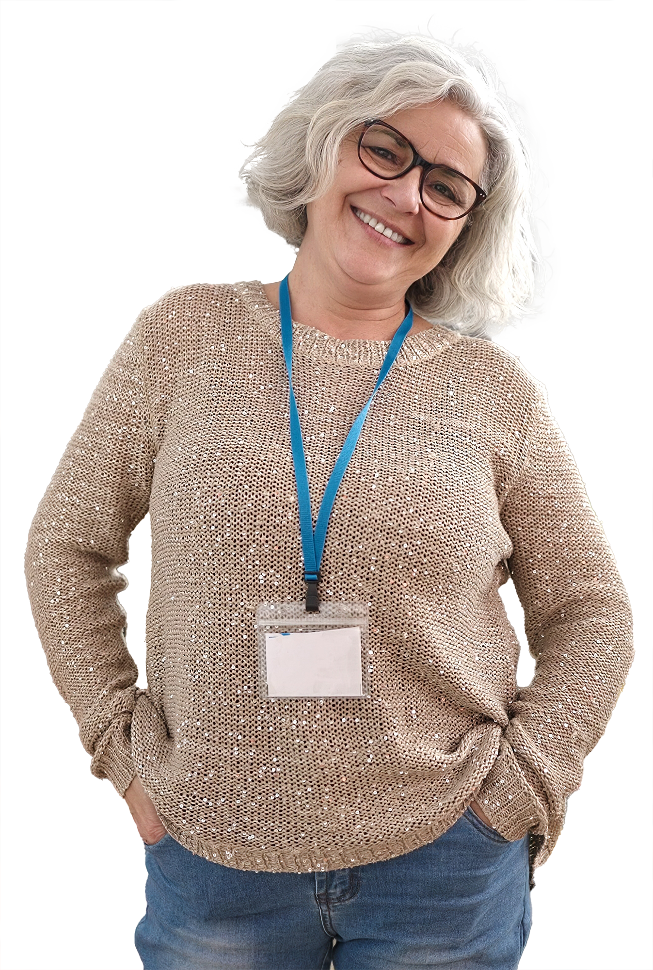 photo of a woman with grey hair and glasses, wearing an attendee badge. She is smiling casually, with her hands in her pockets.